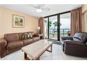 Oceanfront living room with leather furniture and balcony access at 2301 S Atlantic Ave # 306, Daytona Beach Shores, FL 32118
