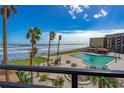 Oceanfront pool with lounge chairs and picnic tables at 2301 S Atlantic Ave # 306, Daytona Beach Shores, FL 32118