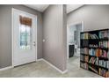 Bright entryway with front door, built-in shelving, and nearby bathroom at 537 Champion Ridge Dr, Daytona Beach, FL 32124