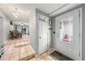 Clean entryway with tile flooring, coat closet, and view to dining area at 246 Angeles Rd, Debary, FL 32713