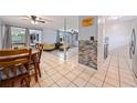 Open concept dining area with wood table and chairs, view of living room at 246 Angeles Rd, Debary, FL 32713