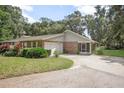 Brick ranch house with attached garage and screened porch at 2600 S Glen Eagles Dr, Deland, FL 32724