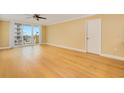 Spacious living room with hardwood floors and sliding doors to balcony at 2947 S Atlantic Ave # 301, Daytona Beach Shores, FL 32118