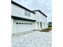 White two-story house with a gray paved driveway at 1991 Peel Ave, Orlando, FL 32806