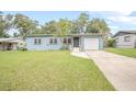 Ranch style home with a newly painted exterior, driveway, and grassy yard at 333 Beresford Ave, Deland, FL 32724