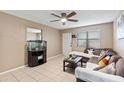 Living room with sectional sofa, fish tank, and ceiling fan at 114 Palm Dr, Daytona Beach, FL 32117