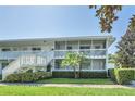 Front view of a two-story building with white railings and landscaping at 1140 S Orlando Ave # F-16, Maitland, FL 32751