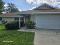 One-story house with attached garage and a neat front yard at 1461 N Felton St, Deltona, FL 32725