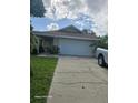 Two-car garage and a well-maintained front yard at 1461 N Felton St, Deltona, FL 32725