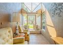 Sunroom with tiled floor and vintage furniture at 5411 Canna Ct, Port Orange, FL 32128