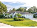 Charming one-story house with a two-car garage and well-maintained lawn at 107 Brandiwood Ct, Debary, FL 32713