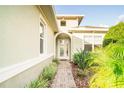 Front entry with a brick walkway and lush landscaping at 1401 Palisades Ln, Deland, FL 32724