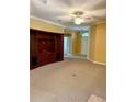 Spacious living room with neutral carpeting and built-in entertainment center at 101 Avenham Dr, Deland, FL 32724