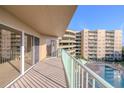 Spacious balcony overlooking the pool and neighboring building at 4 Oceans West Blvd # 407B, Daytona Beach Shores, FL 32118