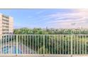 Balcony overlooking a pool, lush landscape, and scenic waterway at 4 Oceans West Blvd # 407B, Daytona Beach Shores, FL 32118