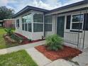 Updated home with a sunroom and well-maintained landscaping at 869 Roberts Blvd, Deltona, FL 32725