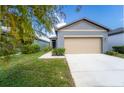 Gray house with a tan garage door and walkway at 2245 Litchfield Loop, Deland, FL 32720