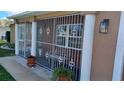 Covered front porch with decorative iron railings and brick flooring at 1165 Anderson St, Deltona, FL 32725