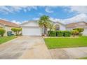 Single-story home with attached garage and landscaped yard at 316 Dahoon Holly Dr, Daytona Beach, FL 32117
