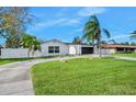 Modern home with circular driveway and landscaping at 822 N Beach St, Ormond Beach, FL 32174