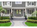 Gray double front doors, white columns, and manicured landscaping at 4 Broad Creek Cir, Ormond Beach, FL 32174