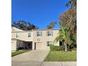 Two story townhome with attached garage, landscaping, and palm tree at 1630 Primo Ct, Daytona Beach, FL 32117