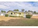 Rear exterior view of the house with a spacious yard at 10170 Sw 96Th Ct, Ocala, FL 34481