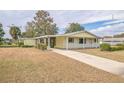 Ranch style home with a long driveway and mature trees at 10170 Sw 96Th Ct, Ocala, FL 34481