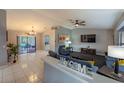 Living room with blue couches, large TV, and view of pool at 1020 Hanford Dr, Deltona, FL 32738