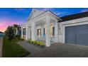Two-story home with front porch, gray siding, and a two-car garage at 53 Marden Dr, Ormond Beach, FL 32176
