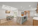 Modern kitchen with island, stainless steel appliances, and light wood cabinets at 1873 Spruce Creek Blvd, Port Orange, FL 32128