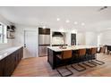 Modern kitchen with island, stainless steel appliances, and dark cabinets at 932 Parkwood Dr, Ormond Beach, FL 32174