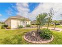 Landscaped yard with tropical plants at 1156 Champions Dr, Daytona Beach, FL 32124