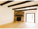 Living room with stone fireplace and wood beams at 1899 S Lehigh Dr, Deltona, FL 32738