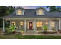 House exterior with a red door and rocking chairs at 5711 John Anderson Hwy, Flagler Beach, FL 32136
