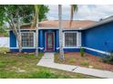 House exterior with walkway, landscaping, and front door at 1171 Daimler Dr, Apopka, FL 32712