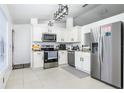 Modern kitchen with stainless steel appliances and granite countertops at 1171 Daimler Dr, Apopka, FL 32712