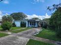 White single-story house with a driveway and landscaping at 1777 Oasis Ave, Deltona, FL 32725