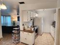 Bright kitchen with white cabinets and modern appliances at 1777 Oasis Ave, Deltona, FL 32725