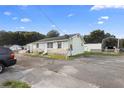 Commercial building with parking and adjacent structure at 2490 N Woodland Blvd, Deland, FL 32720