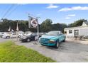 Commercial property with cars in front and signage at 2490 N Woodland Blvd, Deland, FL 32720
