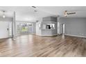 Open concept living room and kitchen with luxury vinyl plank flooring at 2730 Woodland Dr, Edgewater, FL 32141