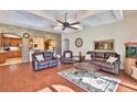 Spacious living room with leather furniture, hardwood floors, and kitchen view at 3344 S Ridgewood Ave, Port Orange, FL 32129