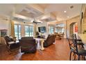 Open floor plan living room with recessed ceiling, fireplace and access to backyard at 3344 S Ridgewood Ave, Port Orange, FL 32129