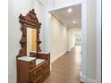 Long hallway with hardwood floors and antique furniture at 425 Sandy Bluff Trl, Deland, FL 32724