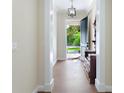 Elegant entryway with hardwood floors and antique furniture at 425 Sandy Bluff Trl, Deland, FL 32724