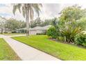 One story house with sidewalk and lush landscaping at 6225 Cranberry Dr, Port Orange, FL 32127