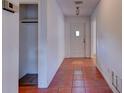 Clean entryway with tile flooring and coat closet at 119 Bigelow Dr, Edgewater, FL 32132