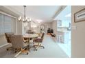 Spacious dining area with a table and chairs, adjacent to kitchen at 4 Oceans West Blvd # 301C, Daytona Beach Shores, FL 32118