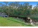 View of a calm canal with lush green vegetation and a small boat dock at 6 Rosalie Oaks Blvd, Lake Wales, FL 33898